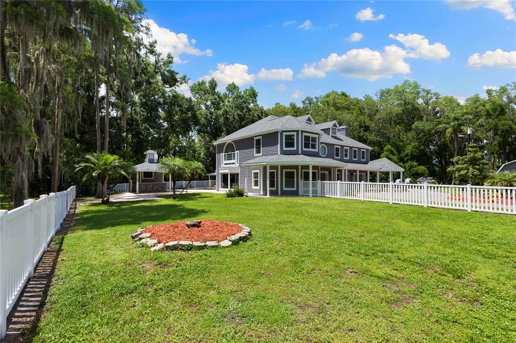 3663 Berger Road Lutz, FL 33548 - Photo 51 of 65 a front view of a house with a yard table and chairs