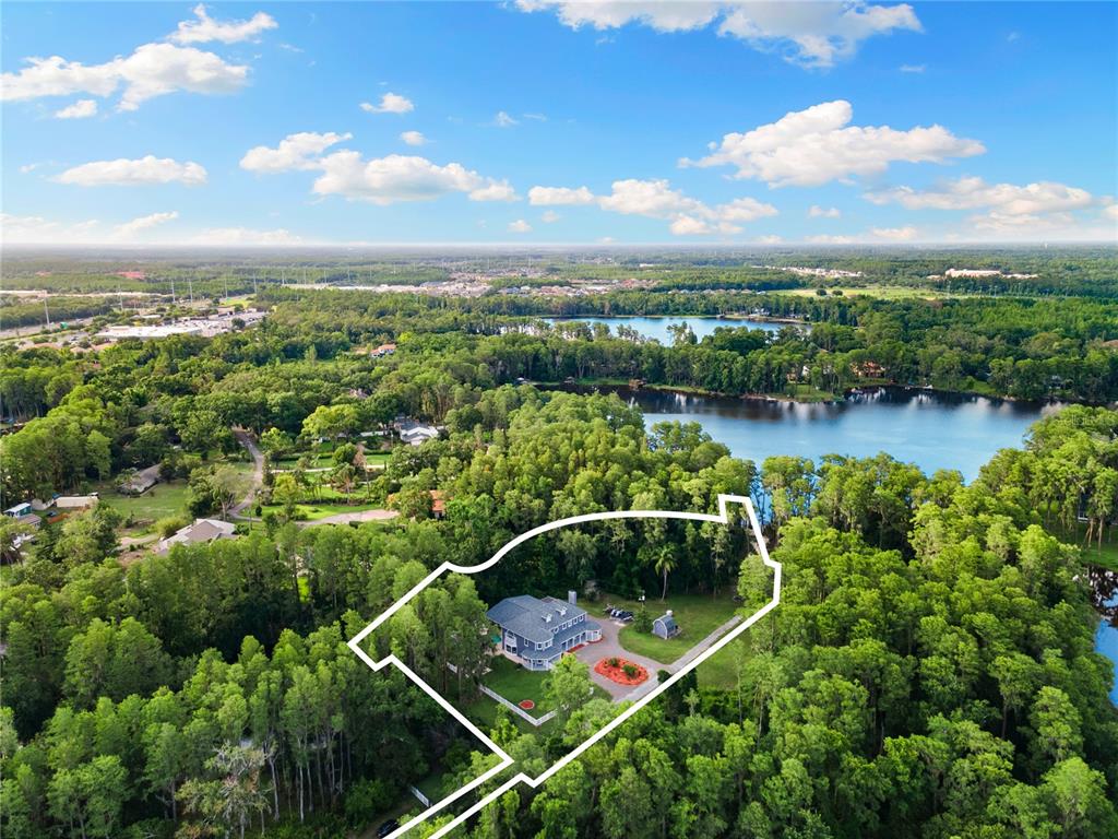 3663 Berger Road Lutz, FL 33548 - Photo 64 of 65 an aerial view of a house with pool lake view and mountain view