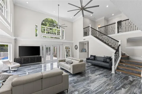 a living room with furniture a fireplace and a large window