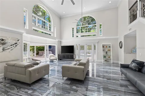a living room with furniture and a chandelier