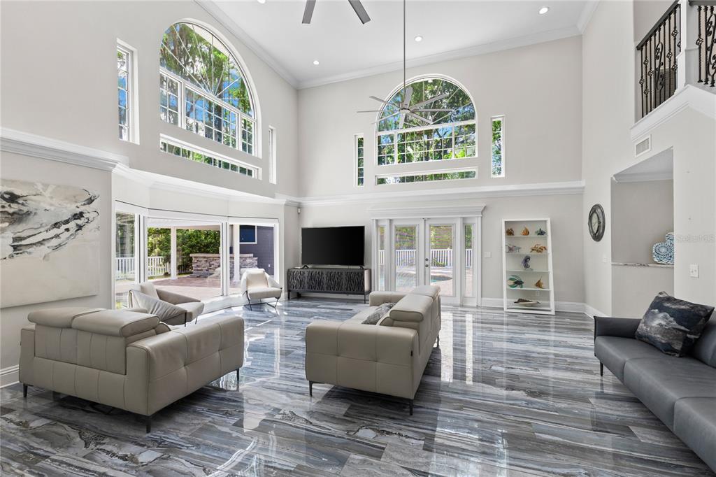 3663 Berger Road Lutz, FL 33548 - Photo 8 of 65 a living room with furniture a fireplace and a large window