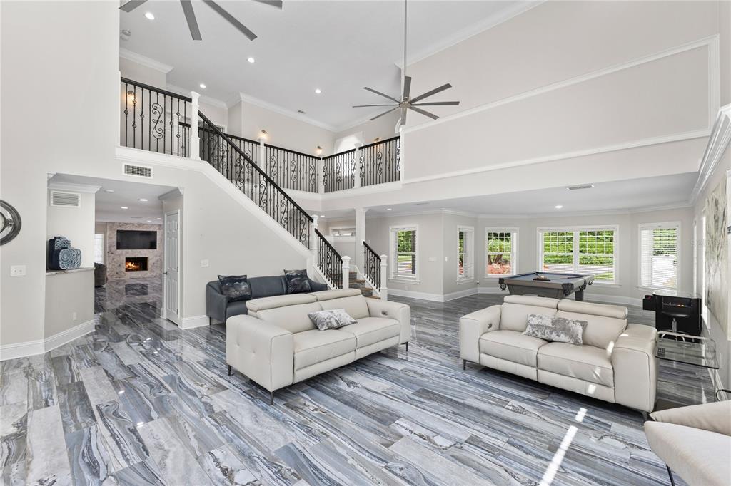 3663 Berger Road Lutz, FL 33548 - Photo 9 of 65 a living room with furniture and a chandelier