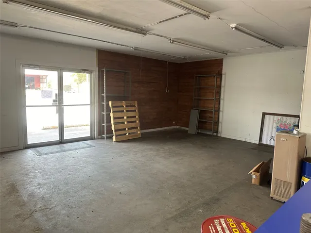 an empty room with a fireplace and window