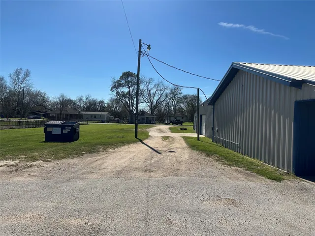 a view of a backyard with swimming pool