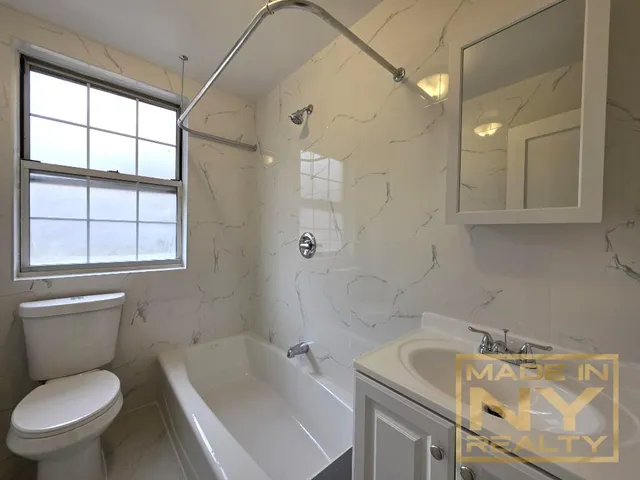 a bathroom with a sink a toilet and tub