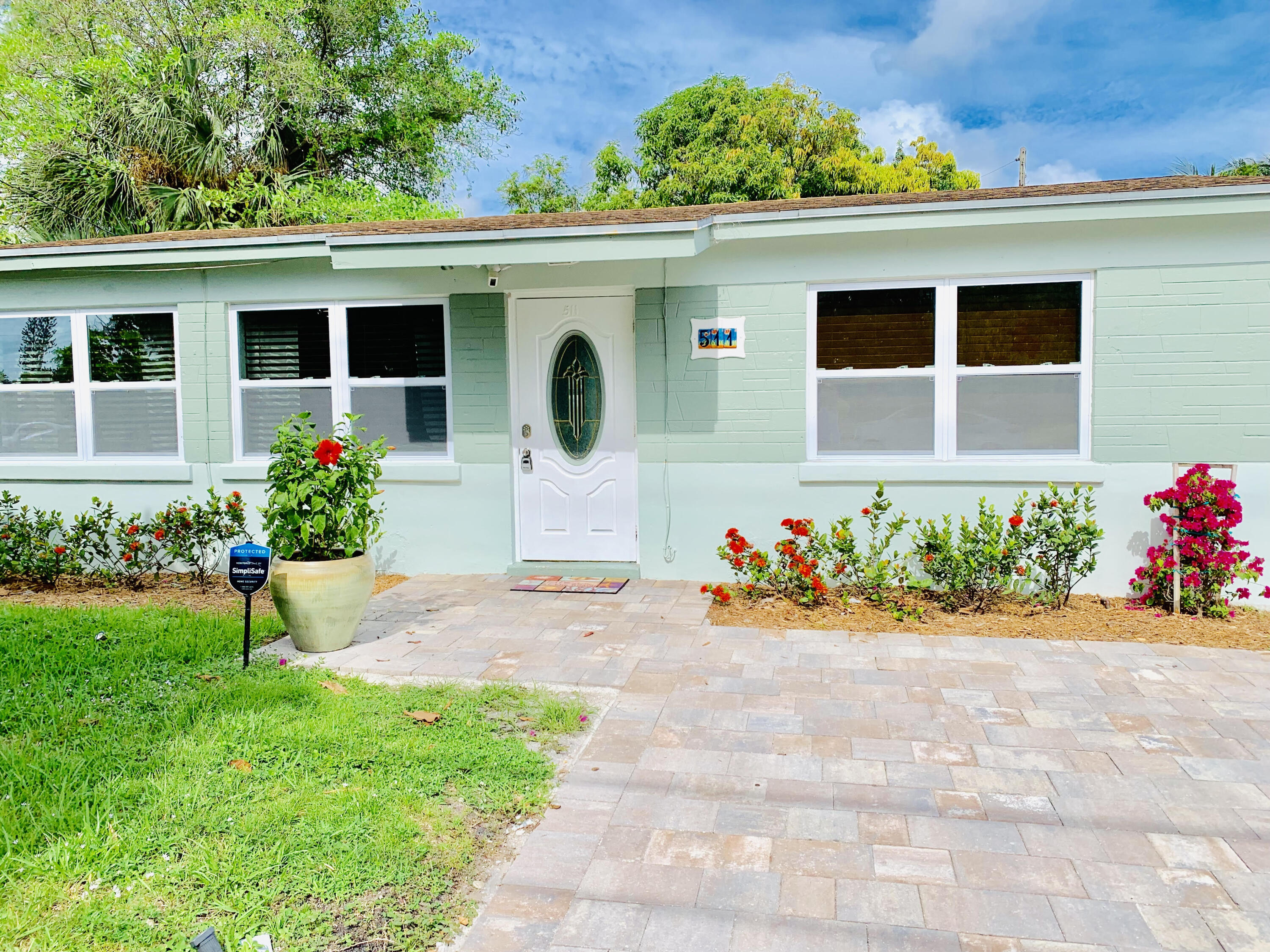 511 Northwest 3rd Street Delray Beach, FL 33444 - Photo 1 of 21 a front view of a house with a yard