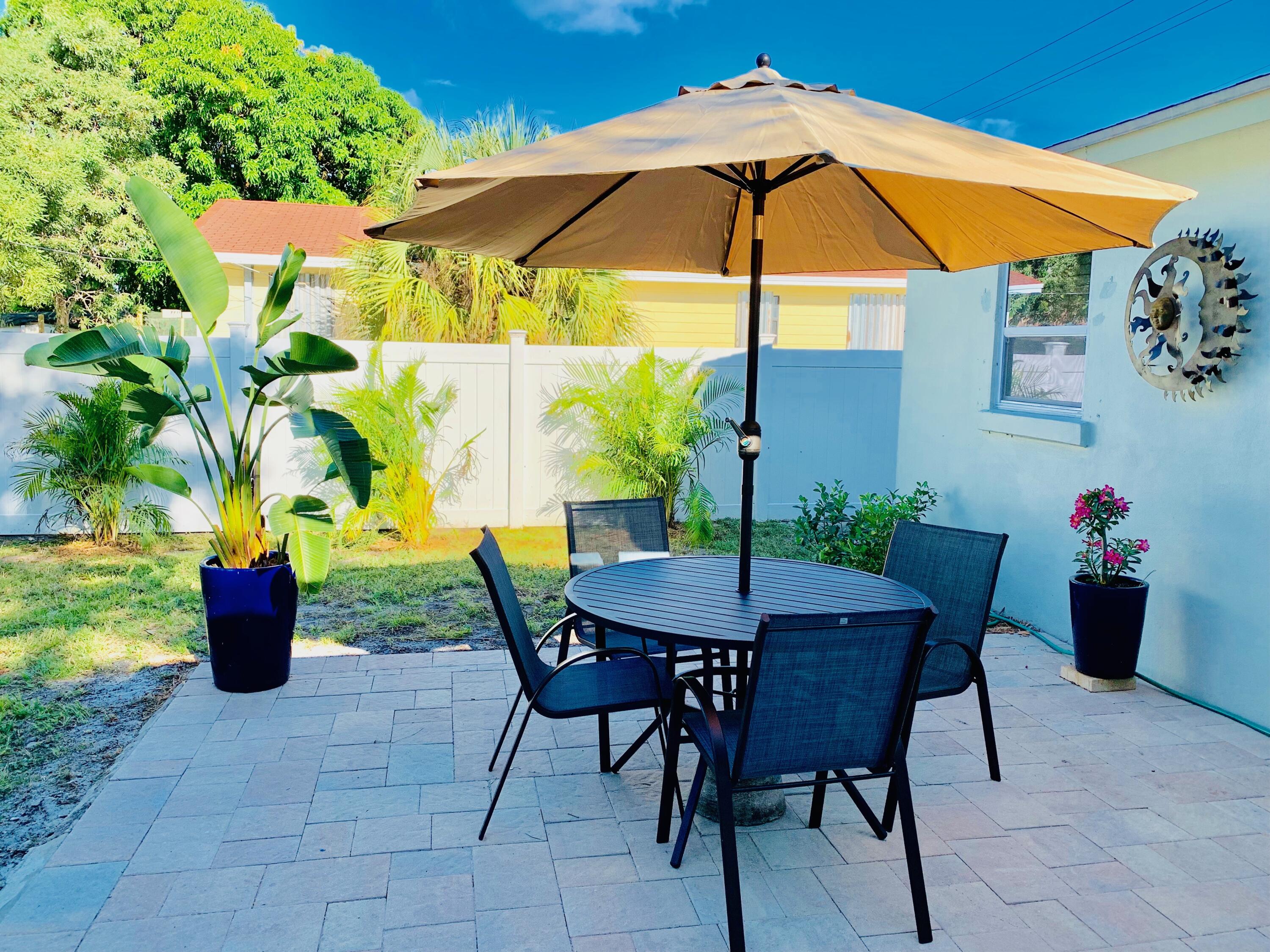511 Northwest 3rd Street Delray Beach, FL 33444 - Photo 2 of 21 a view of an outdoor sitting area with couch and umbrella
