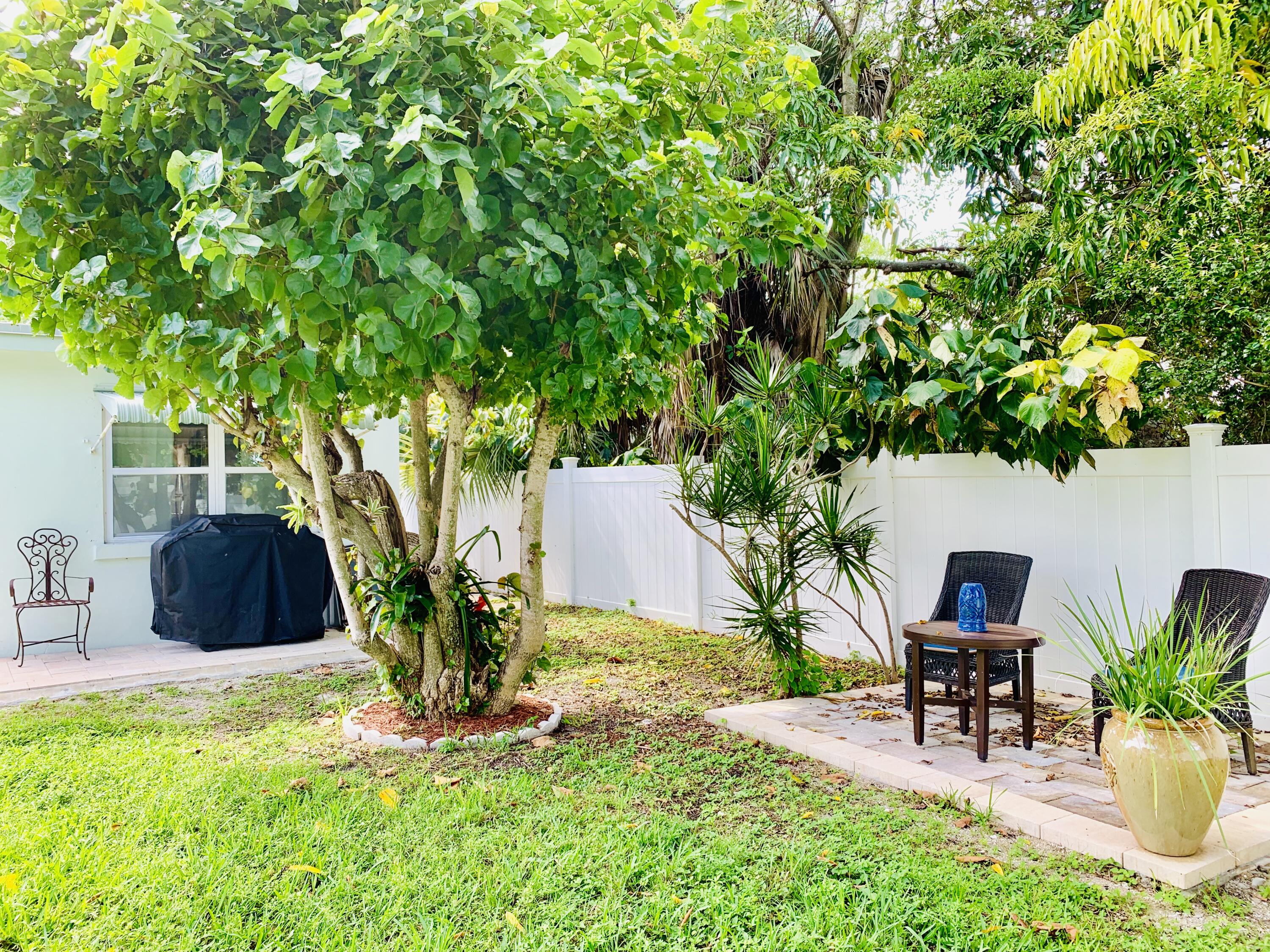 511 Northwest 3rd Street Delray Beach, FL 33444 - Photo 5 of 21 a view of a backyard with table and chairs and potted plants