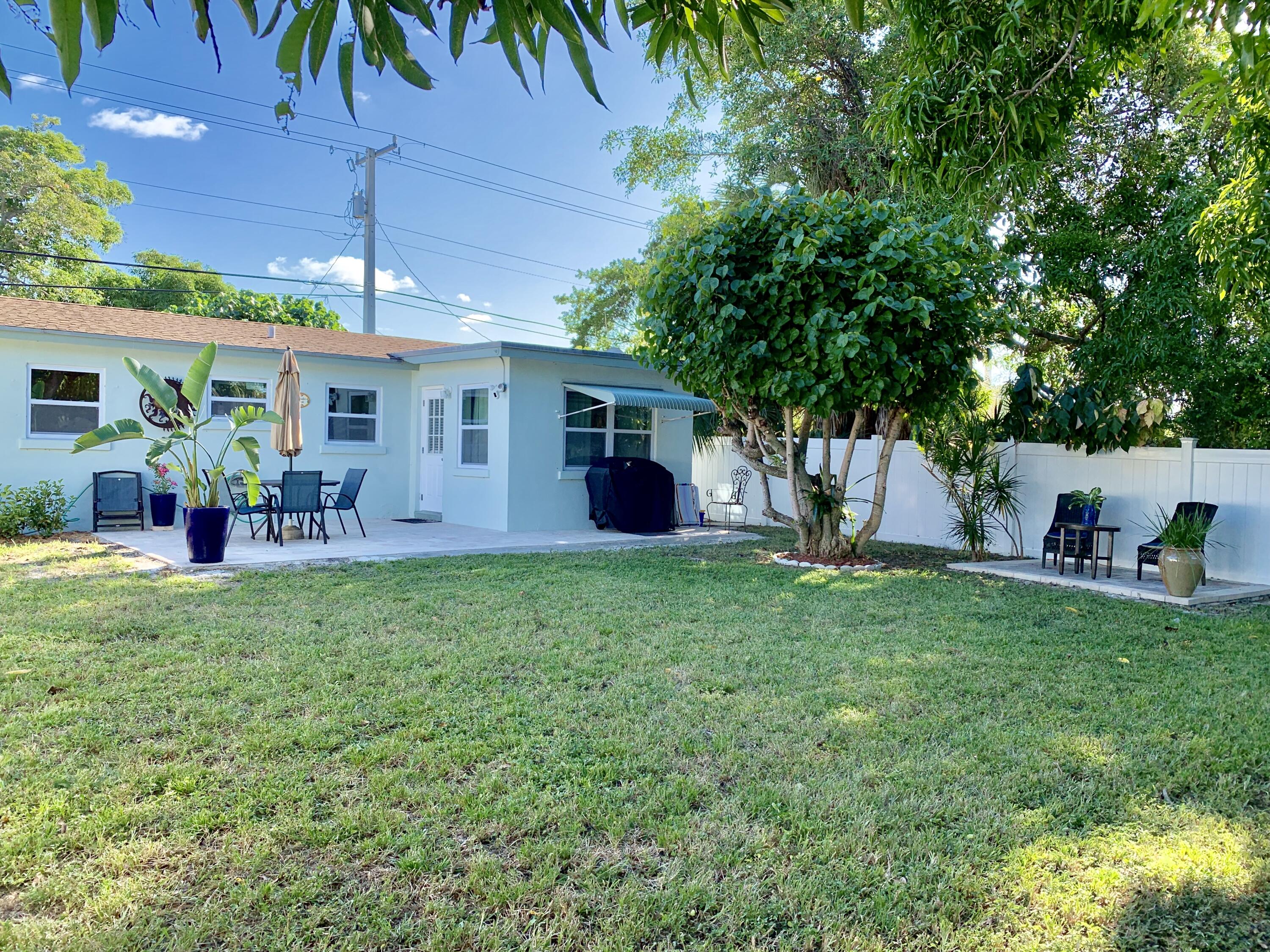 511 Northwest 3rd Street Delray Beach, FL 33444 - Photo 6 of 21 a view of a house with backyard and a garden