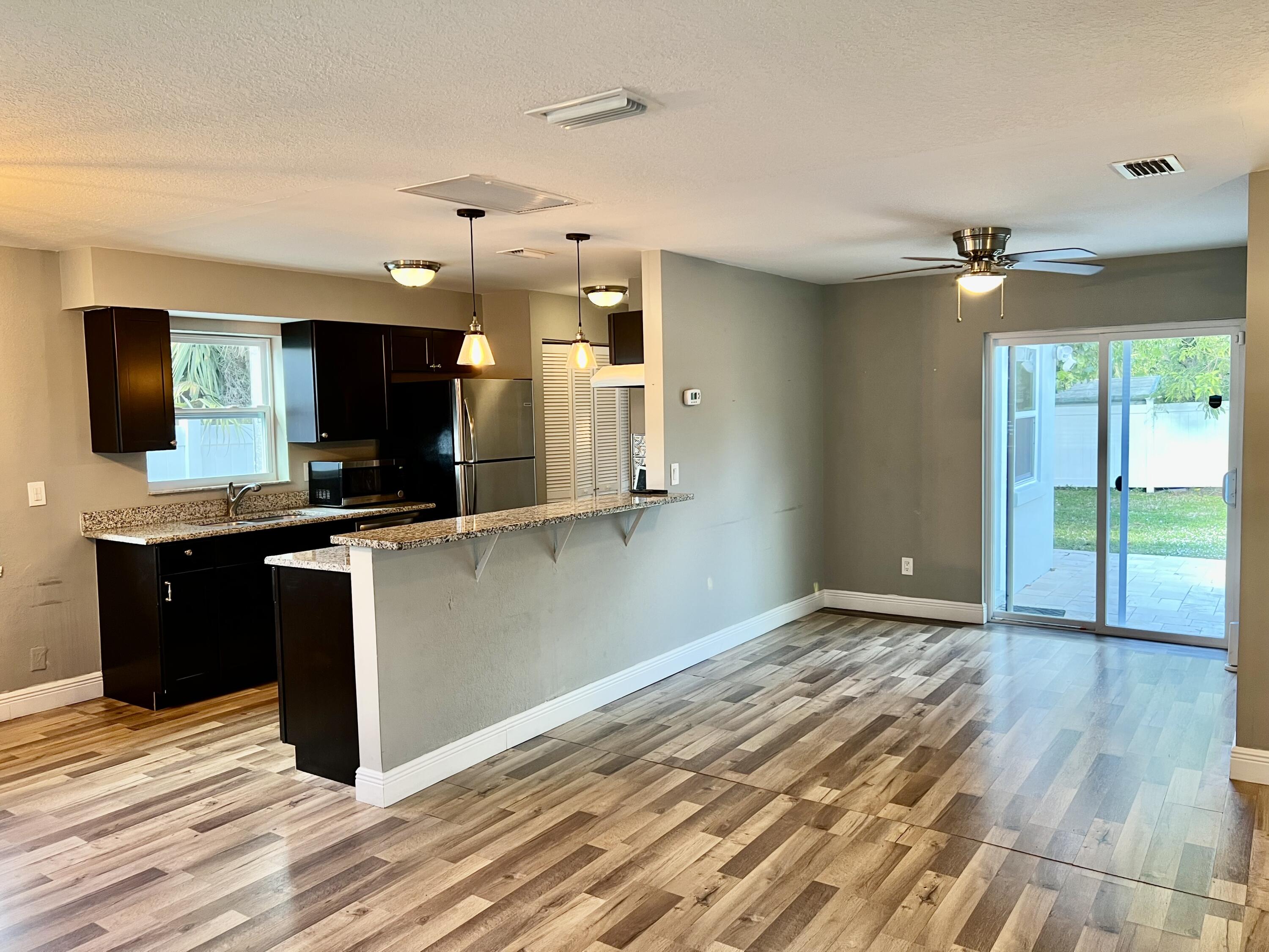 511 Northwest 3rd Street Delray Beach, FL 33444 - Photo 10 of 21 a kitchen with a refrigerator and a stove top oven