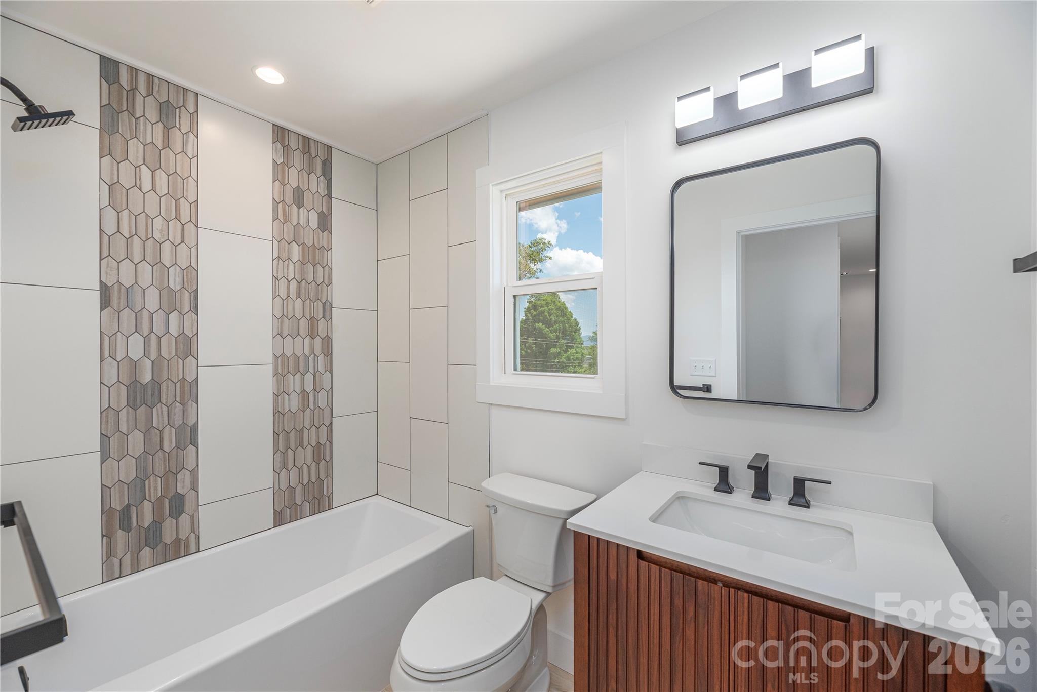 32 Oak Hill Road Candler, NC 28715 - Photo 20 of 29 a bathroom with a sink a toilet and shower