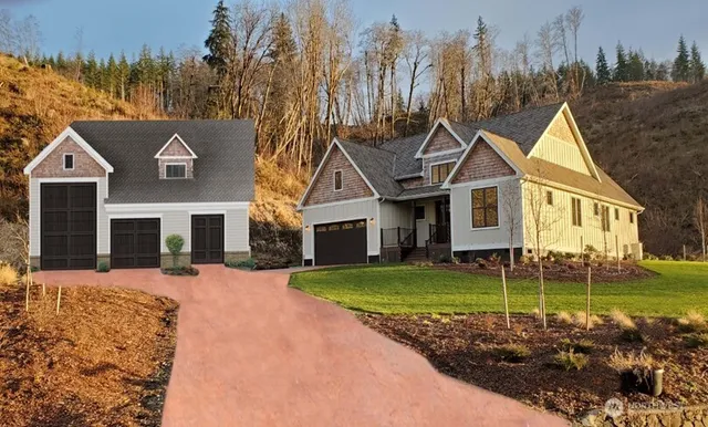 a front view of a house with a garden and yard