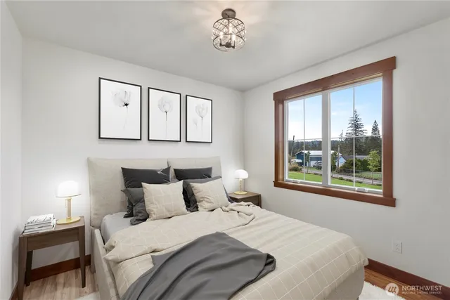 a bedroom with a bed and a window