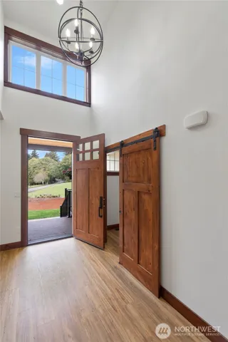 a view of a hallway with wooden floor and staircase