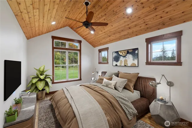 a bedroom with furniture and a large window