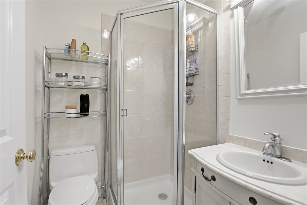73 Myrtle Street, Unit 2 Boston, MA 02114 - Photo 12 of 13 a bathroom with a sink a mirror and a shower