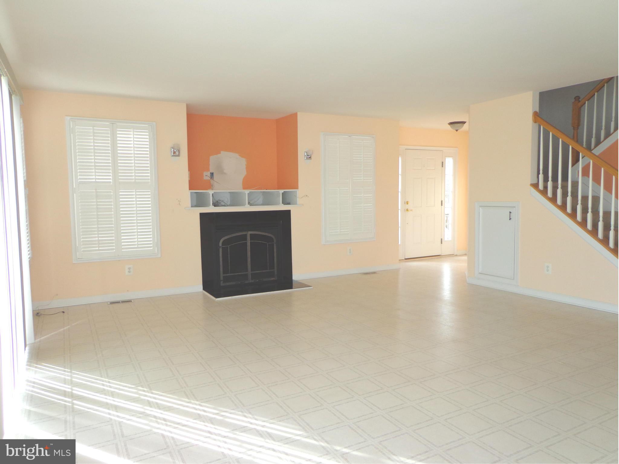 915 Oakdene Road Baltimore, MD 21220 - Photo 11 of 30 a view of empty room with wooden floor and fireplace