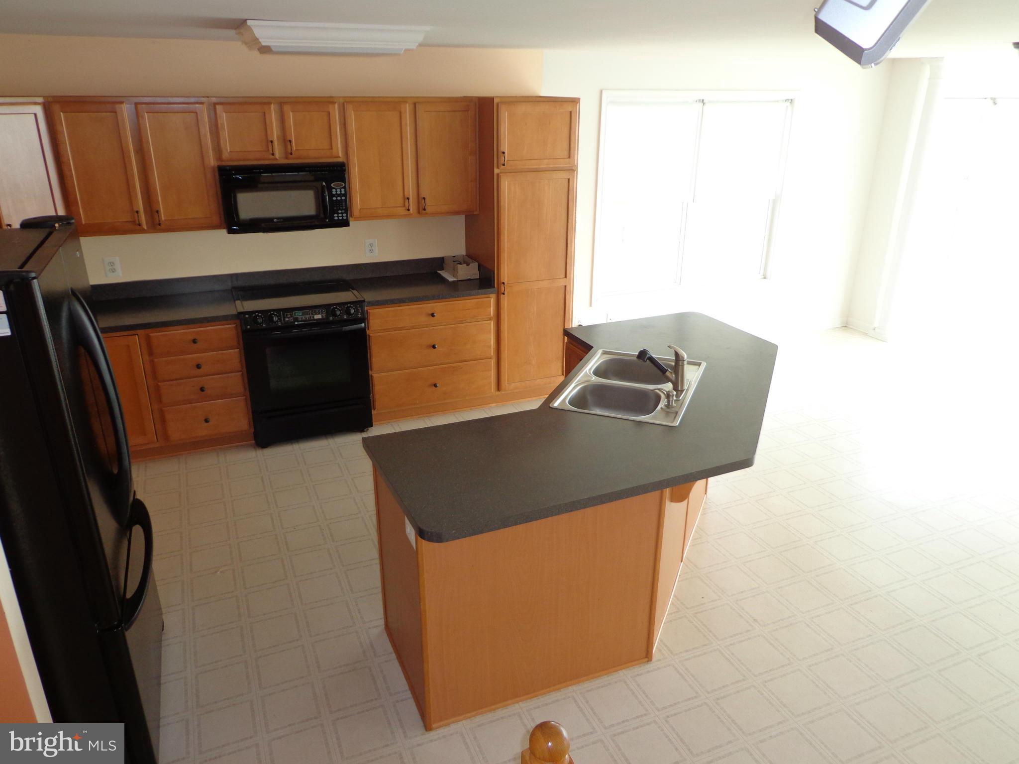 915 Oakdene Road Baltimore, MD 21220 - Photo 8 of 30 a kitchen with stainless steel appliances granite countertop a stove a sink and a refrigerator