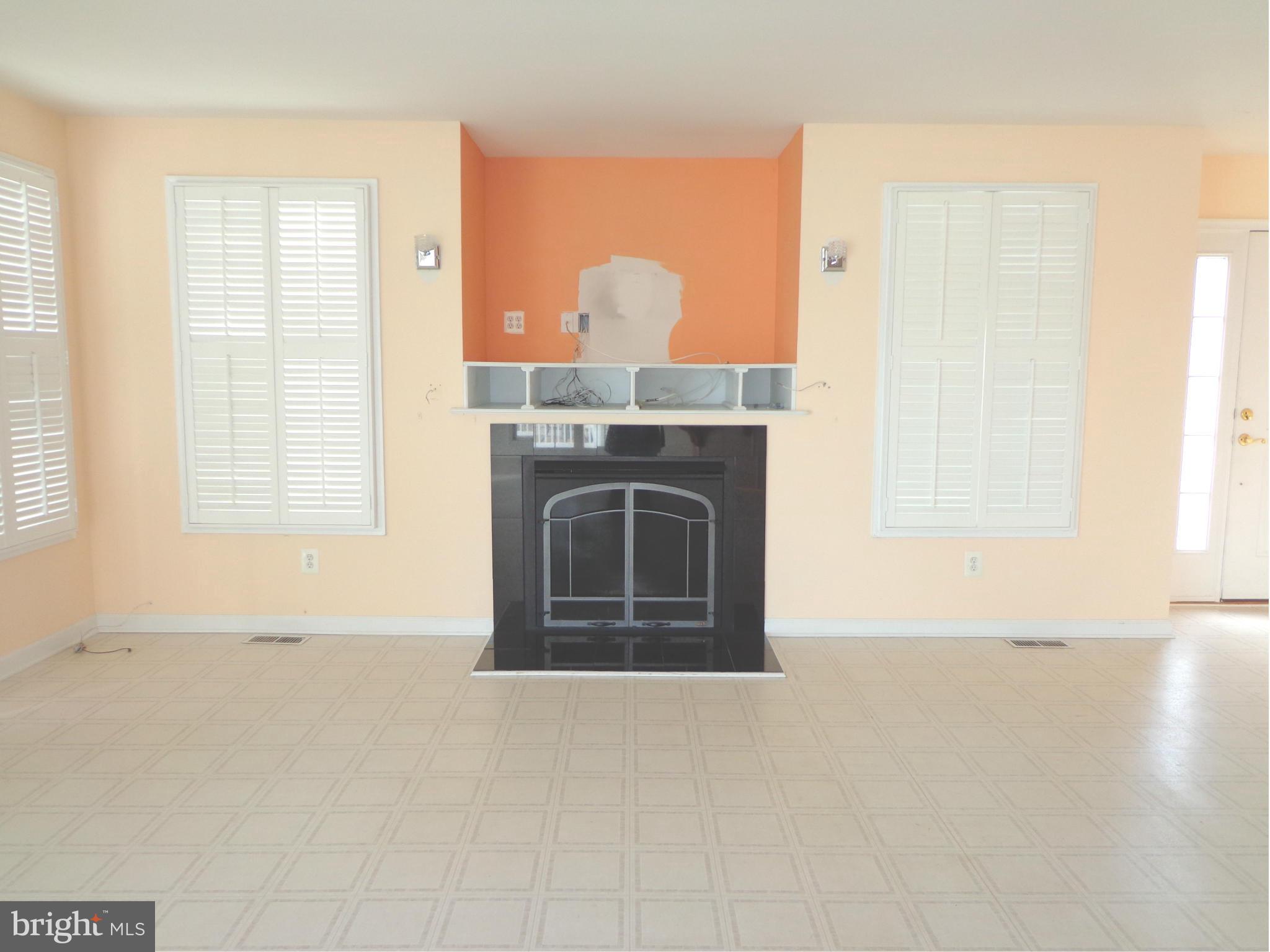915 Oakdene Road Baltimore, MD 21220 - Photo 9 of 30 a view of living room with a fireplace and a window