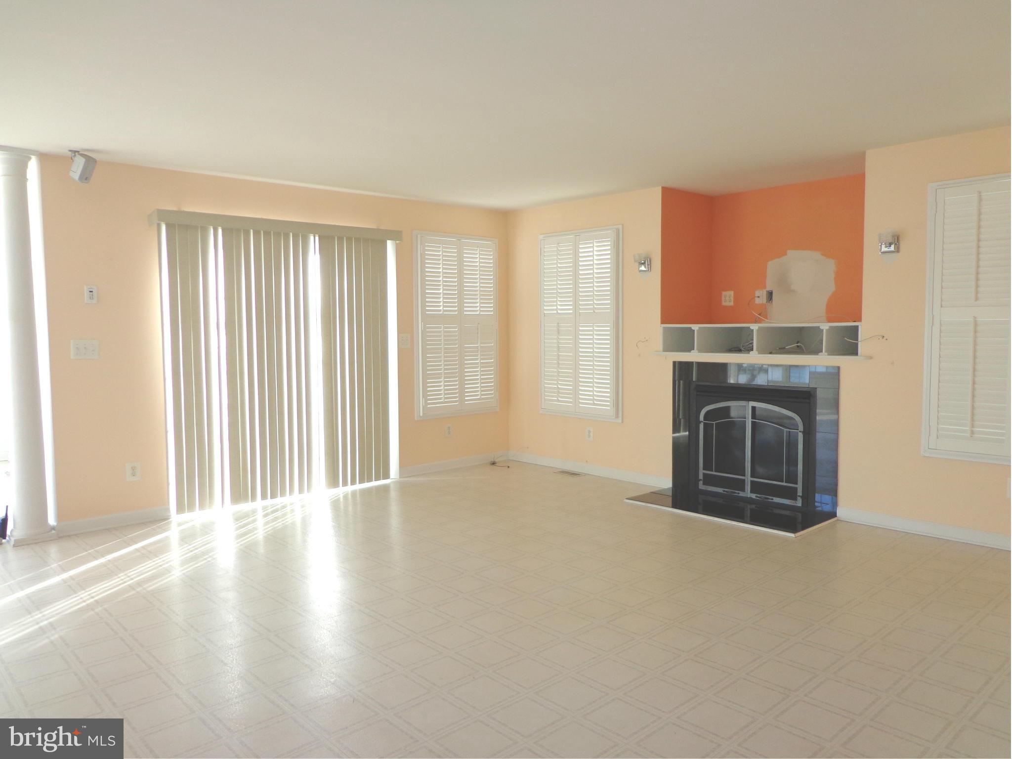 915 Oakdene Road Baltimore, MD 21220 - Photo 10 of 30 an empty room with fireplace and windows