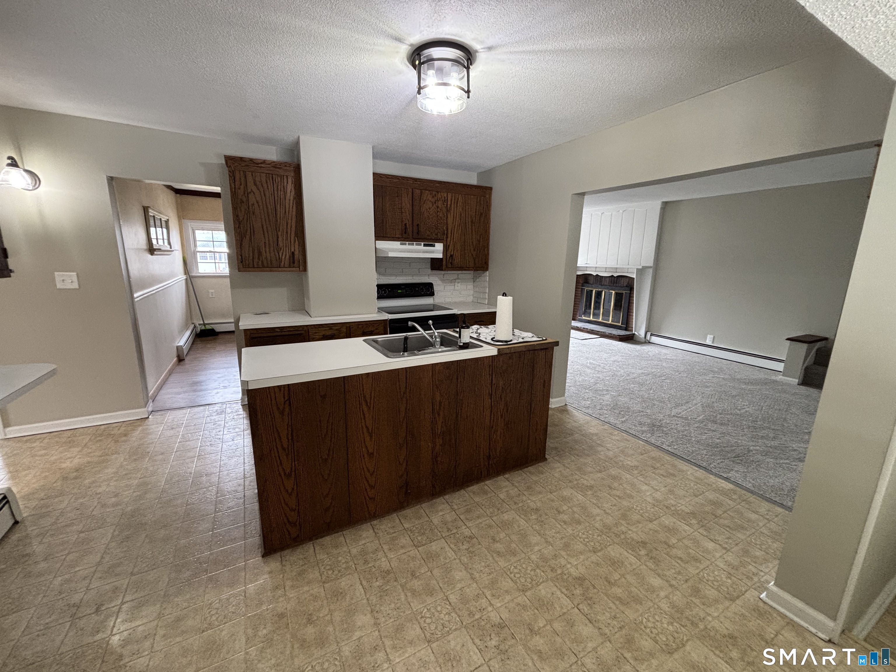 324 Savage Hill Road Berlin, CT 06037 - Photo 20 of 27 a kitchen with stainless steel appliances a stove a sink and a refrigerator