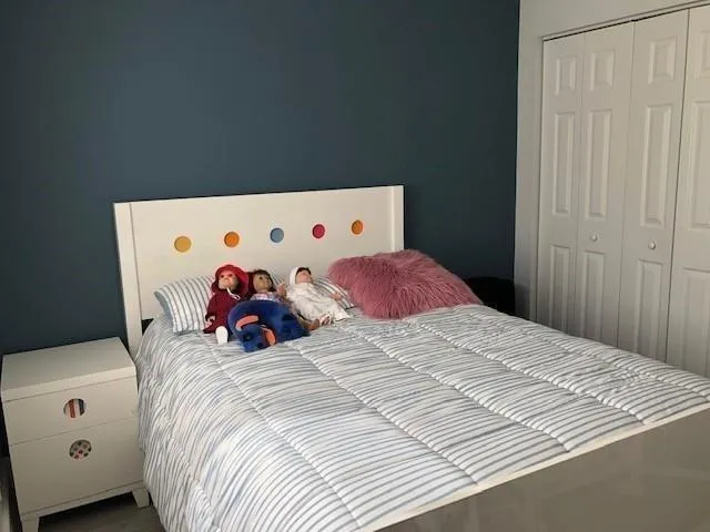 a bed room with a bed and a window