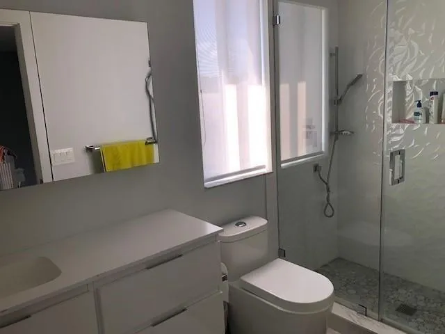 a bathroom with a toilet and a shower