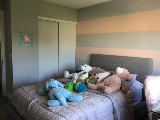 a bed sitting in a bedroom next to a window