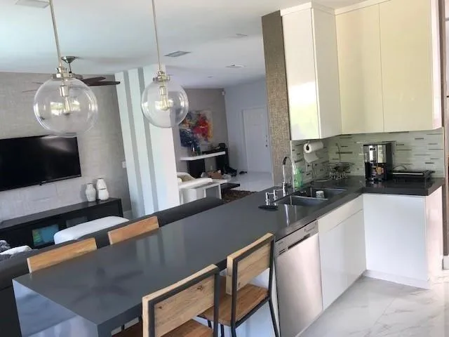 a kitchen with sink and refrigerator