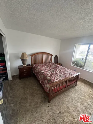 a bedroom with a bed and dresser