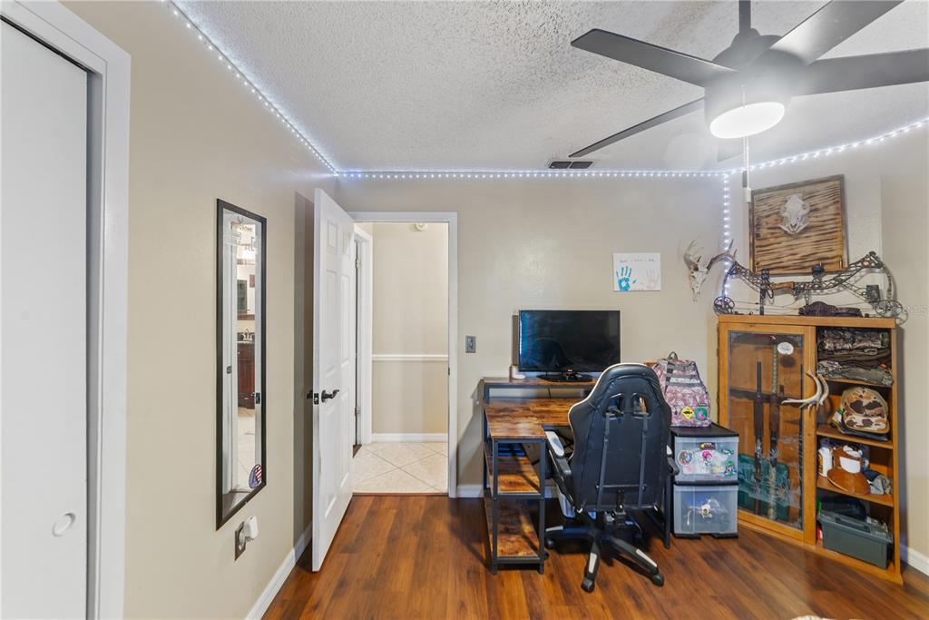 8715 Huntsman Lane Port Richey, FL 34668 - Photo 31 of 54 a view of a workspace with furniture and wooden floor