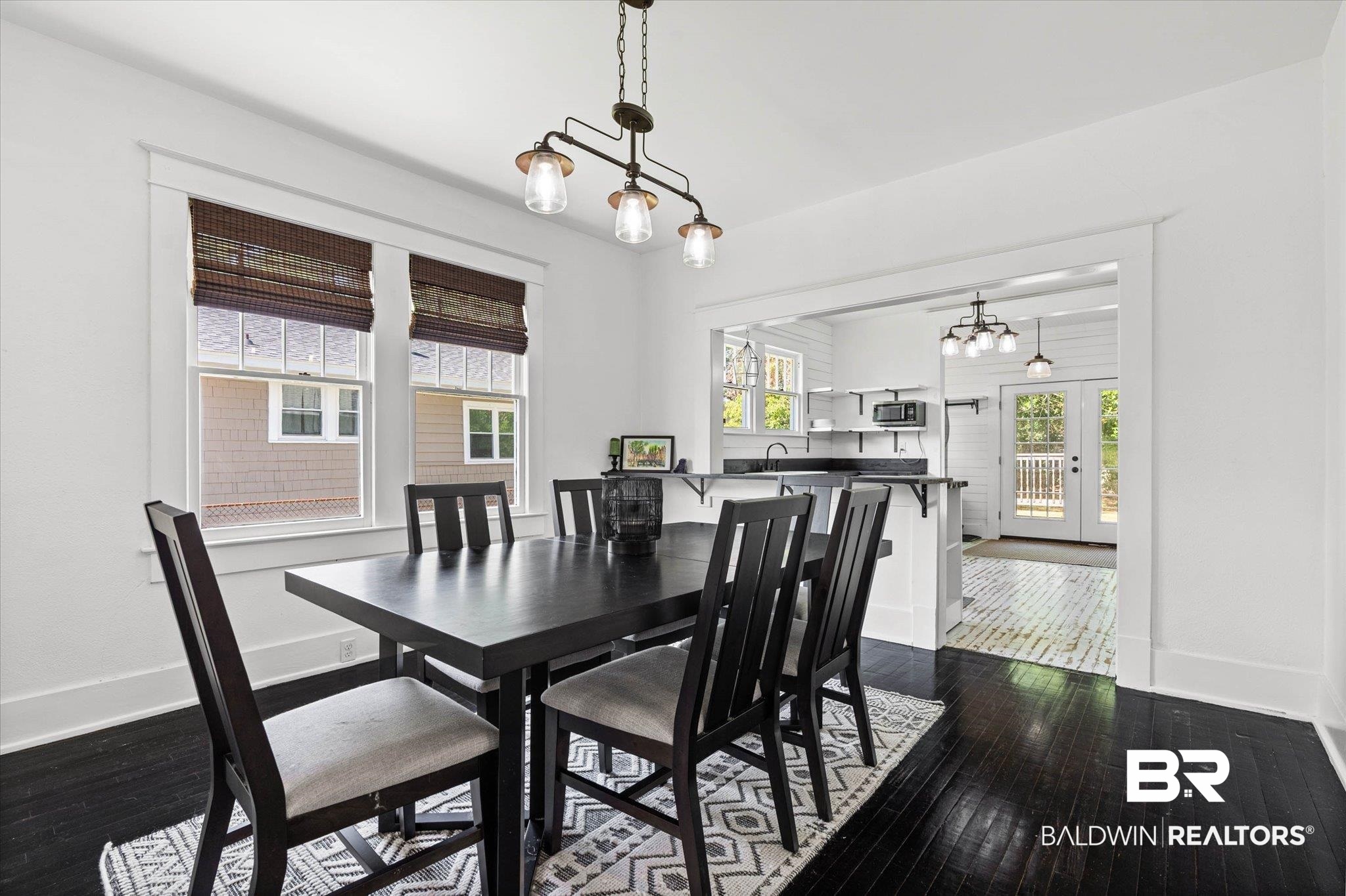121 North Carlen Street Mobile, AL 36607 - Photo 5 of 21 Dining space featuring dark wood-type flooring, a chandelier, and french doors