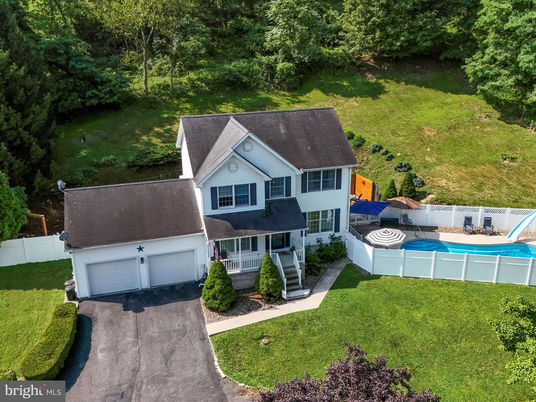 an aerial view of a house with swimming pool garden and patio