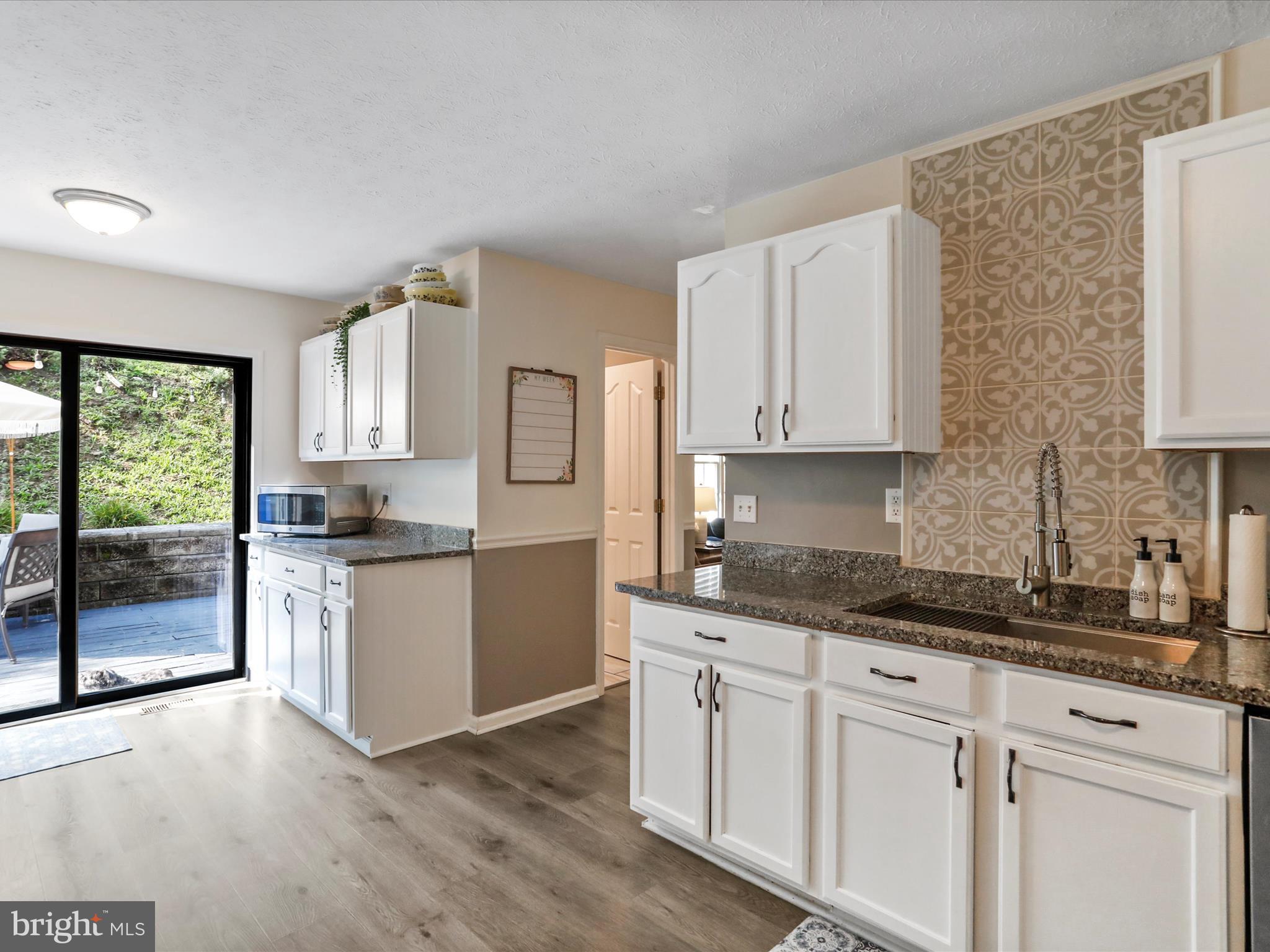 339 D Street Keyser, WV 26726 - Photo 20 of 47 a kitchen with granite countertop white cabinets and white appliances