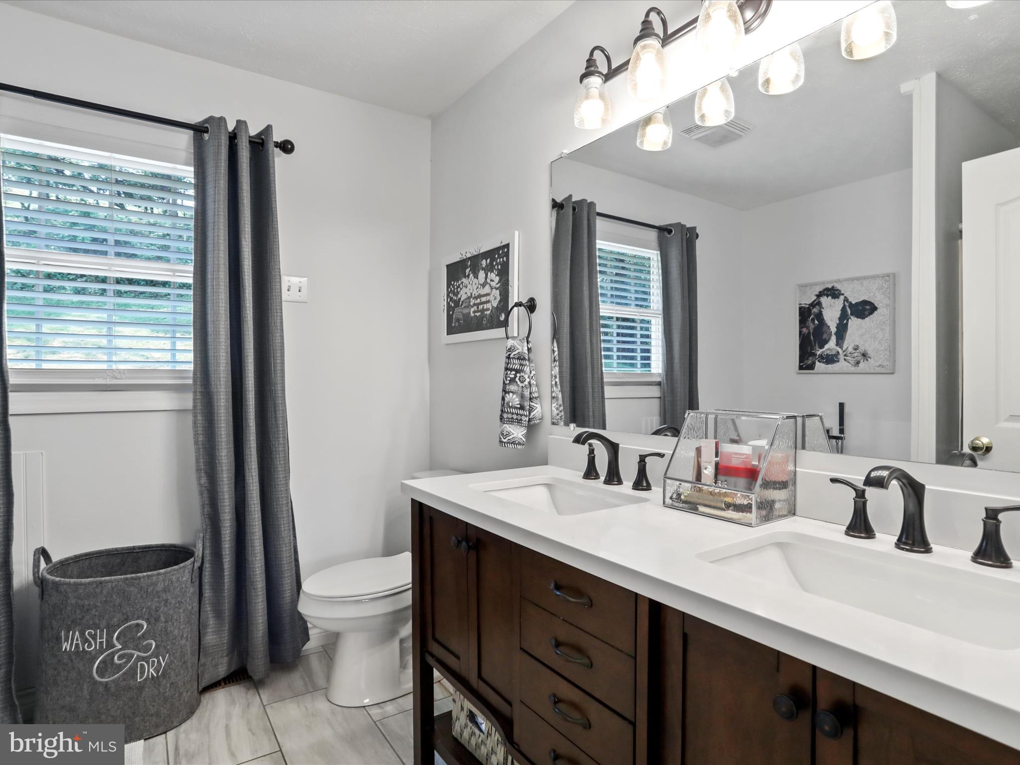 339 D Street Keyser, WV 26726 - Photo 24 of 47 a bathroom with a double vanity sink toilet and a mirror