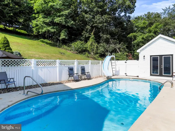 swimming pool view with a outdoor seating