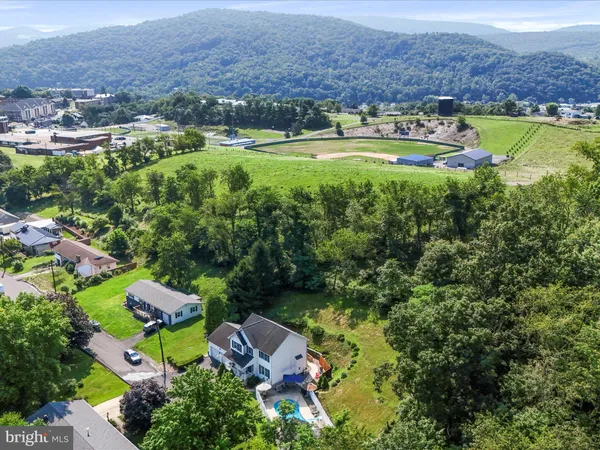 an aerial view of a houses with a yard