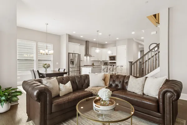 a living room with furniture kitchen and a table