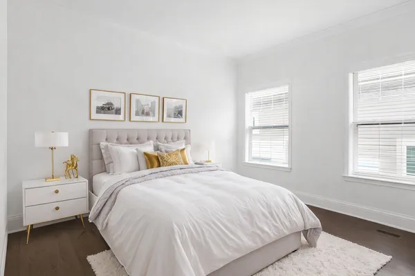 a spacious bedroom with a bed and a window
