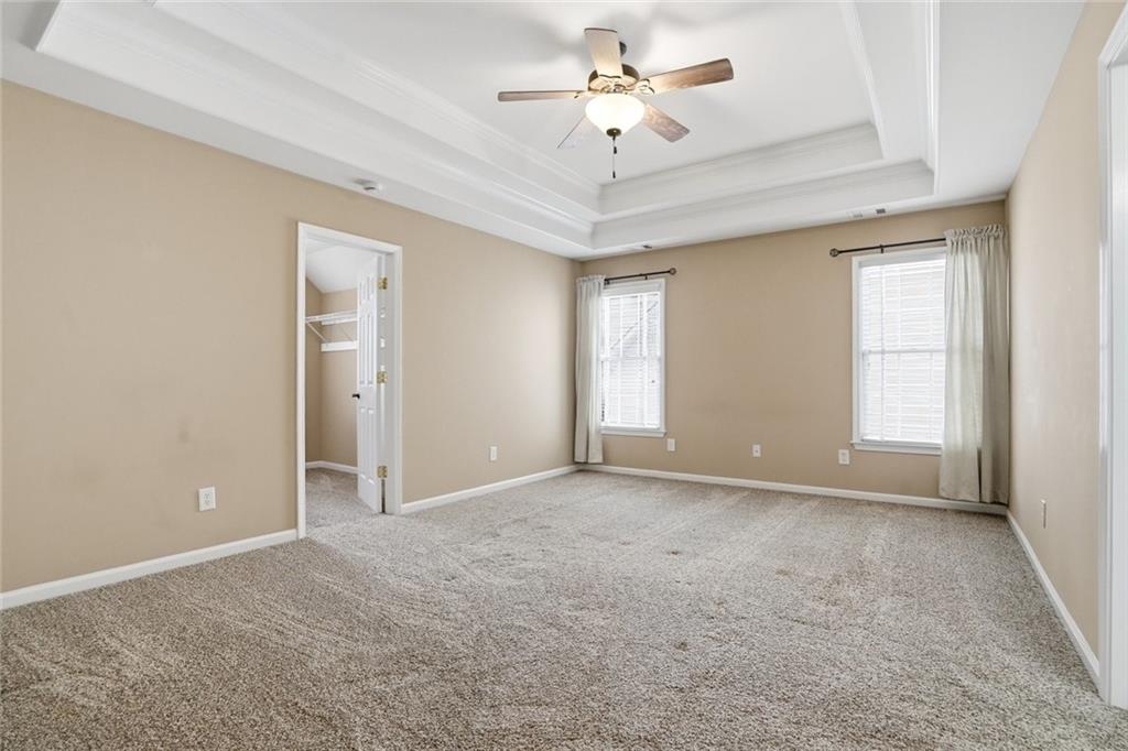 855 Freedom Way Cumming, GA 30040 - Photo 13 of 25 an empty room with windows and fan