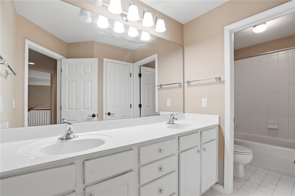 855 Freedom Way Cumming, GA 30040 - Photo 15 of 25 a bathroom with a sink a toilet and shower