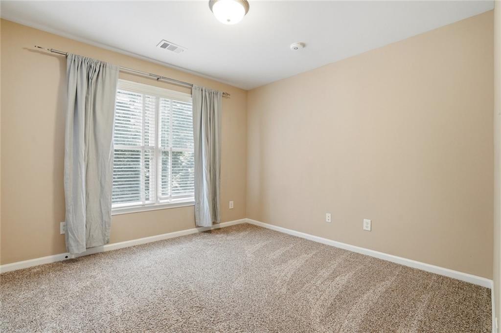 855 Freedom Way Cumming, GA 30040 - Photo 16 of 25 a view of an empty room with a window