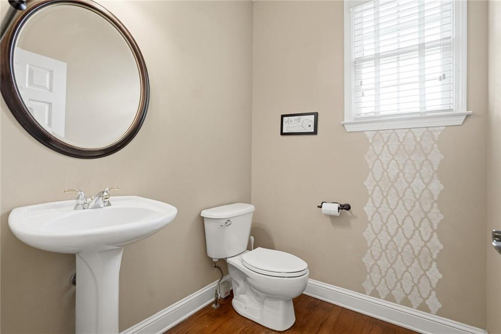 855 Freedom Way Cumming, GA 30040 - Photo 19 of 25 a bathroom with a sink a mirror and a toilet