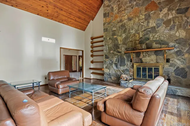 a view of a dining room with furniture large windows and wooden floor