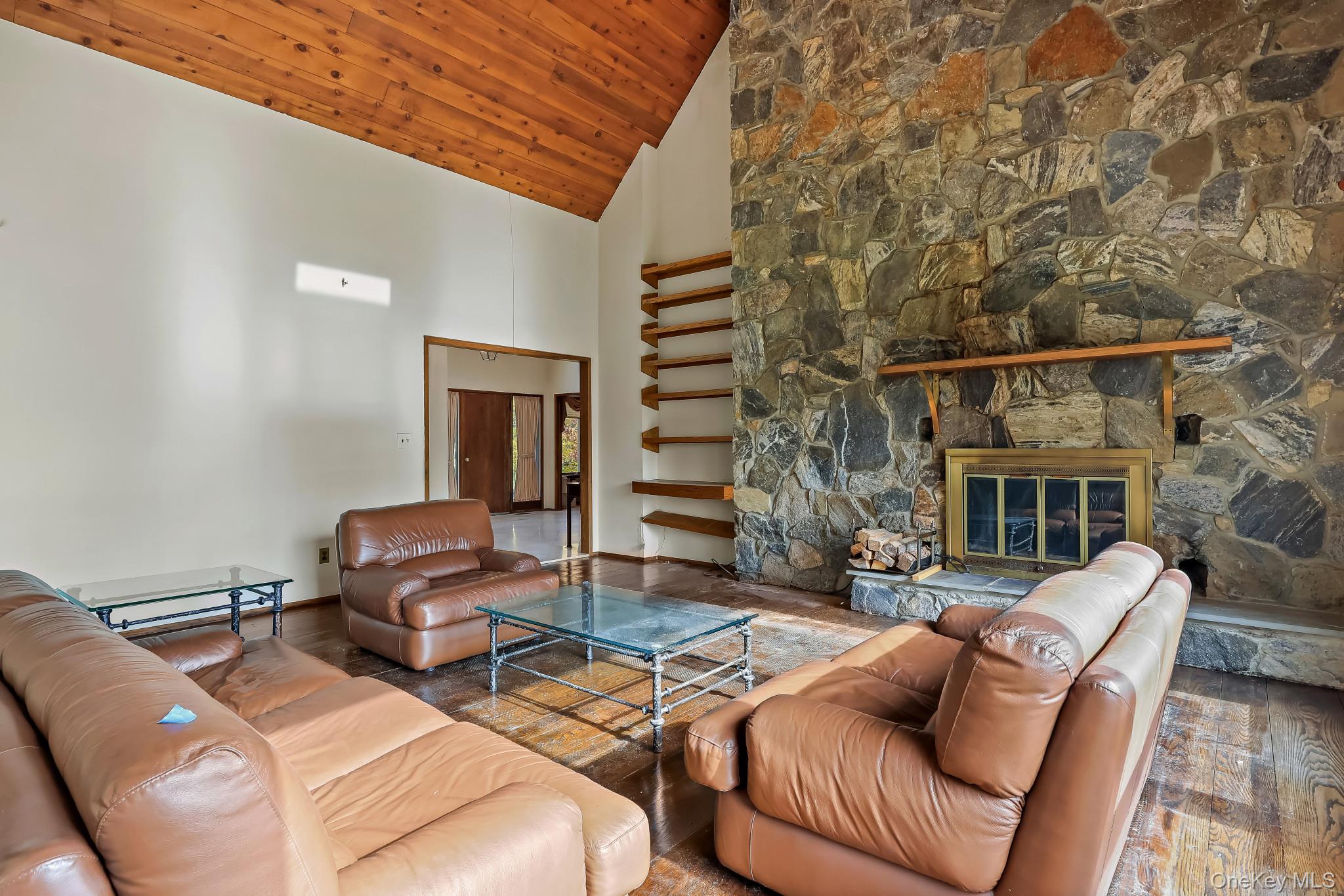 37 Century Trail Harrison, NY 10528 - Photo 12 of 43 Family room with high vaulted ceiling, hardwood / wood-style floors, a fireplace, and wooden ceiling