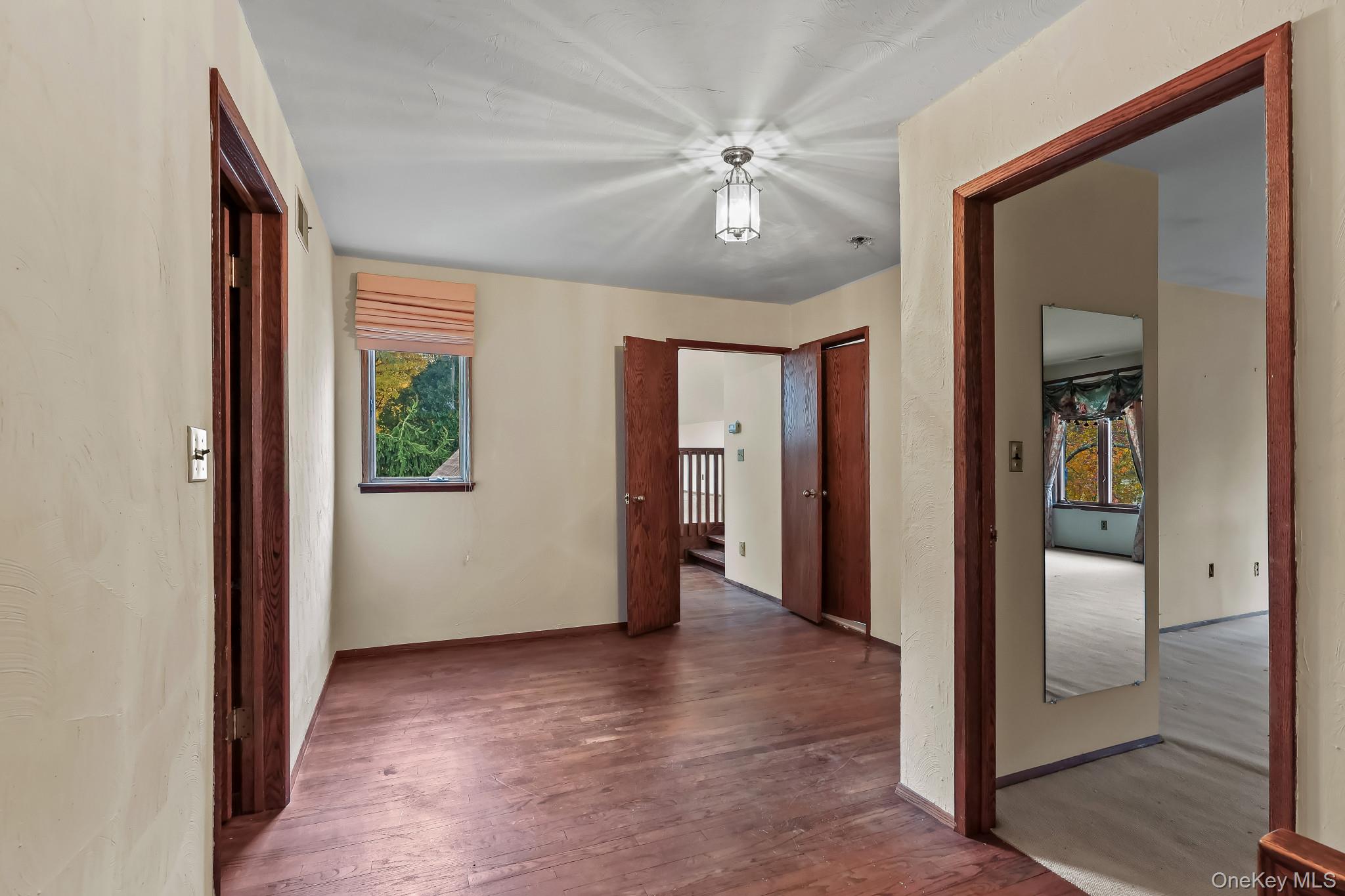37 Century Trail Harrison, NY 10528 - Photo 23 of 43 Hallway featuring hardwood / wood-style floors and healthy amount of natural light