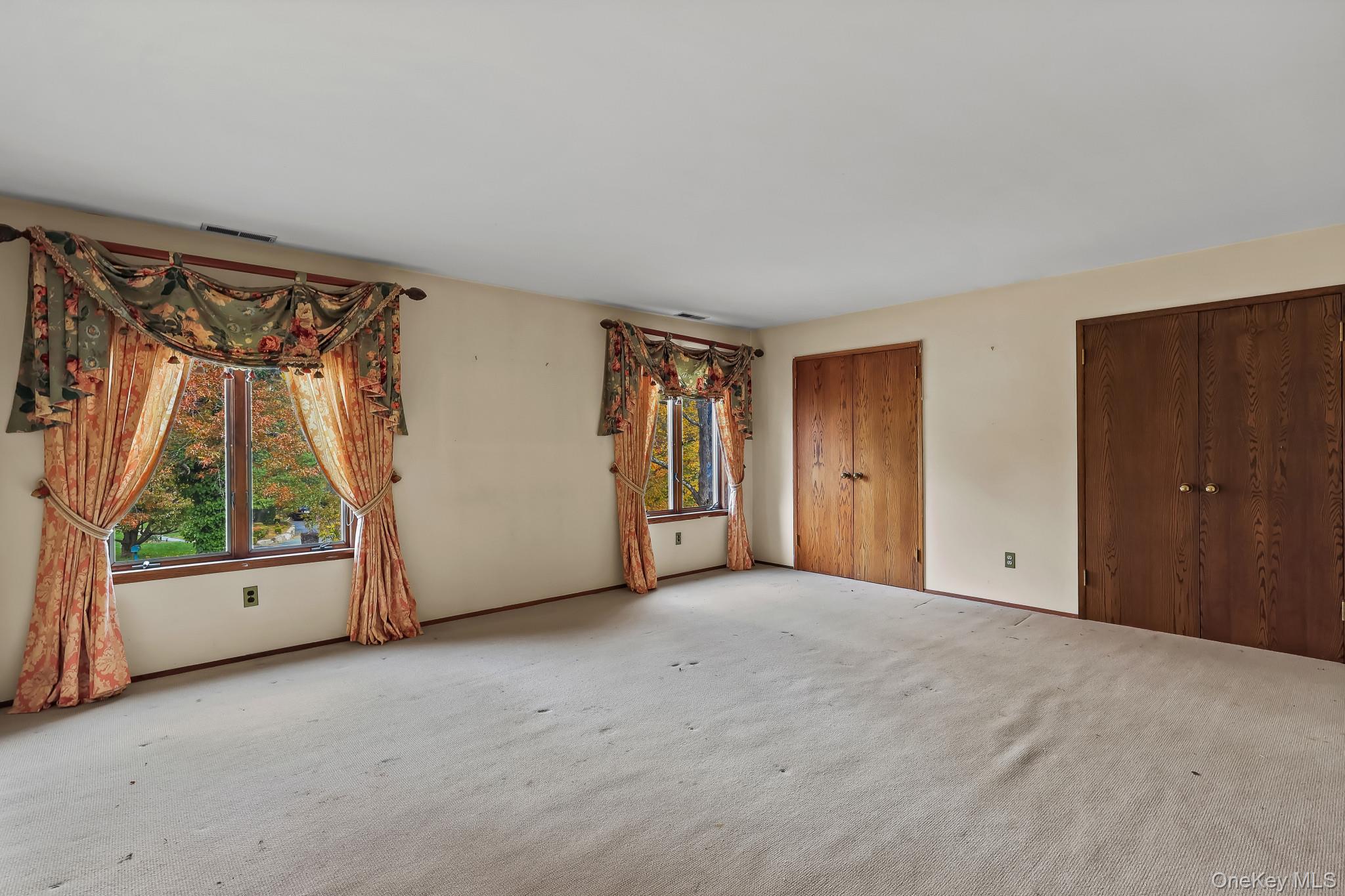 37 Century Trail Harrison, NY 10528 - Photo 24 of 43 Bedroom featuring carpeting and two closets