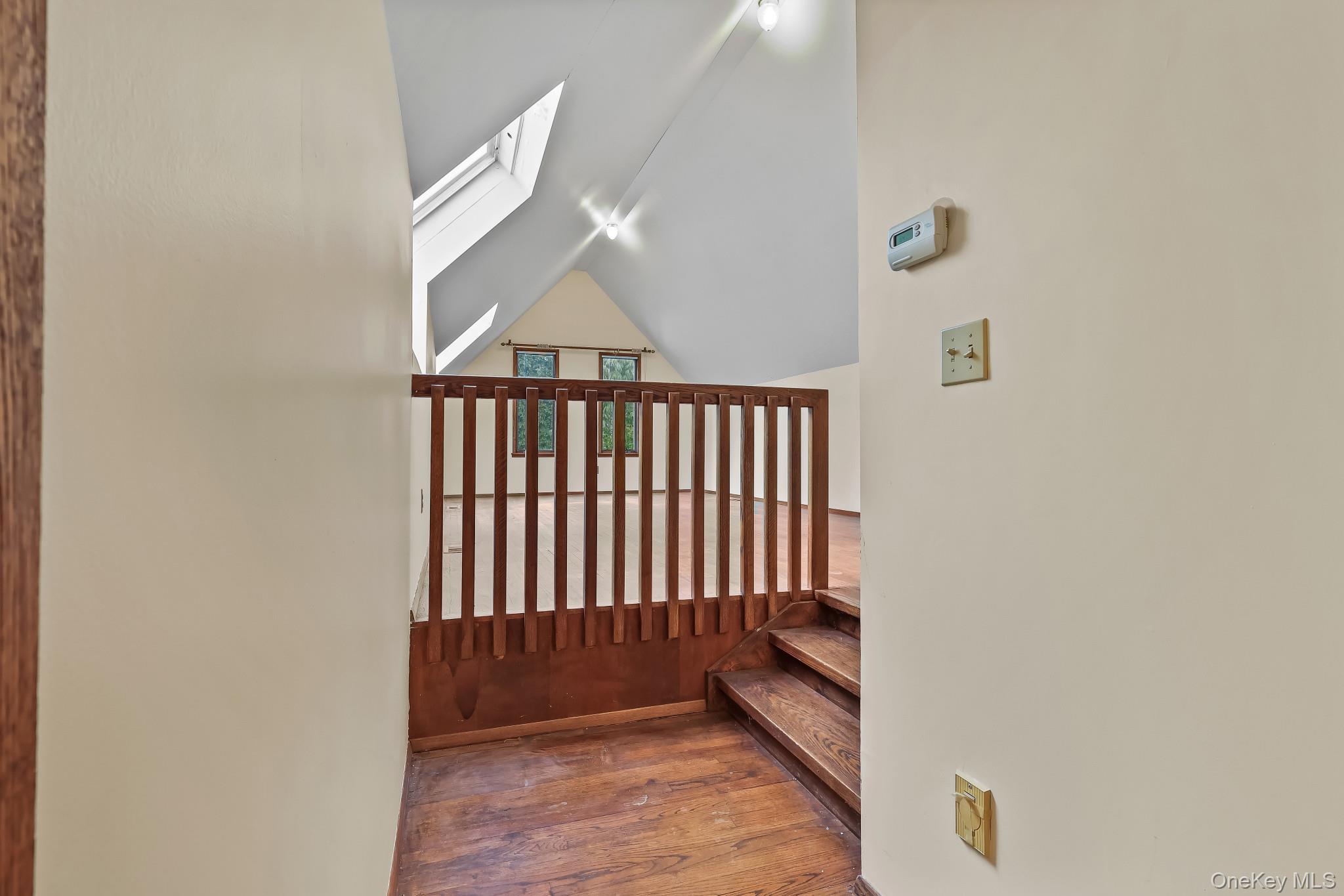 37 Century Trail Harrison, NY 10528 - Photo 26 of 43 Stairs with a skylight, hardwood / wood-style flooring, and vaulted ceiling