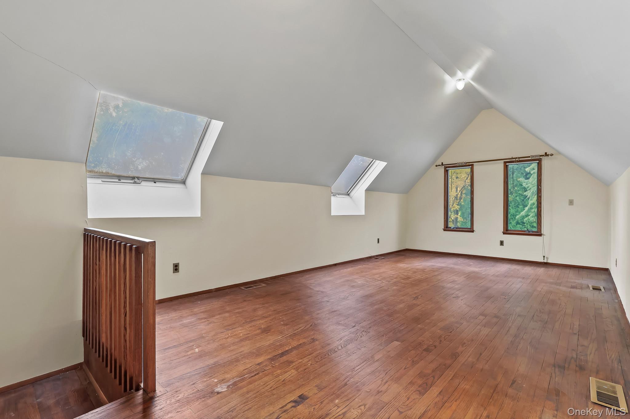 37 Century Trail Harrison, NY 10528 - Photo 27 of 43 Additional living space featuring hardwood / wood-style floors, lofted ceiling, and skylights
