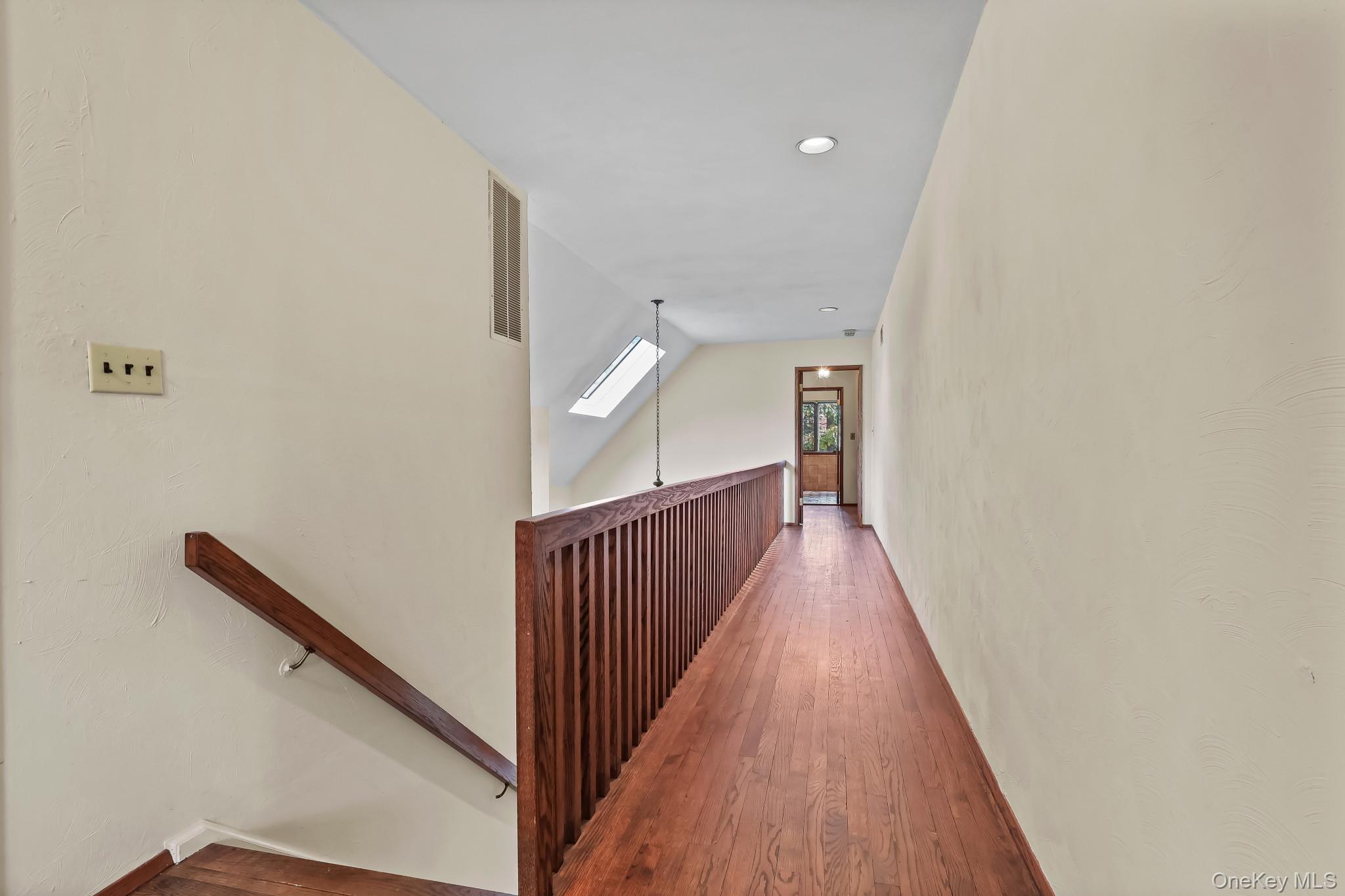 37 Century Trail Harrison, NY 10528 - Photo 28 of 43 Corridor featuring an upstairs landing, hardwood / wood-style floors, recessed lighting, and a skylight